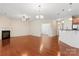 Spacious living room with hardwood floors, a fireplace, and an open layout to the kitchen at 3104 Streamhaven Dr, Indian Land, SC 29707