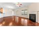 Bright living room featuring hardwood floors, fireplace, and access to the outdoor deck at 3104 Streamhaven Dr, Indian Land, SC 29707