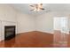 Large living room featuring a fireplace, hardwood floors, and ample natural light at 3104 Streamhaven Dr, Indian Land, SC 29707