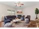 Staged living room featuring a fireplace, hardwood floors, and stylish furniture arrangement at 3104 Streamhaven Dr, Indian Land, SC 29707