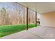 Covered patio overlooking a lush green lawn and wooded area at 3104 Streamhaven Dr, Indian Land, SC 29707