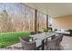 Virtually staged covered patio with outdoor dining and seating at 3104 Streamhaven Dr, Indian Land, SC 29707