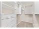 A well-organized walk-in closet with drawers, shelves, and hanging rods at 3104 Streamhaven Dr, Indian Land, SC 29707