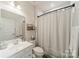 Neat bathroom featuring a sink, toilet, and shower with white tiled backsplash at 3104 Timber Mill Dr, Matthews, NC 28104