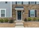 A close-up of the front door entrance with a wreath and stone facade at 3104 Timber Mill Dr, Matthews, NC 28104