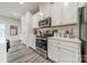 White kitchen cabinets with stainless steel oven and subway tile backsplash at 3104 Timber Mill Dr, Matthews, NC 28104