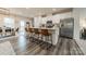 Kitchen with an island, white cabinets, stainless appliances, and hardwood floors at 3104 Timber Mill Dr, Matthews, NC 28104