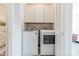 Bright and efficient laundry room equipped with a modern washer and dryer, and storage cabinets at 3104 Timber Mill Dr, Matthews, NC 28104