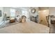 Open-concept living room with staircase, plenty of natural light, and neutral decor at 3104 Timber Mill Dr, Matthews, NC 28104