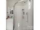 Bright bathroom highlighting a walk-in shower, sink and mirror with modern fixtures and stylish vanity at 326 Whispering Pines Dr, Charlotte, NC 28217