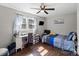 Bedroom showcasing a ceiling fan, large windows, wood floors, and gray paint to create a relaxing atmosphere at 326 Whispering Pines Dr, Charlotte, NC 28217
