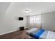 Bedroom with natural light from the window, and hardwood floors, creating a warm and inviting ambiance at 326 Whispering Pines Dr, Charlotte, NC 28217