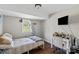 Cozy bedroom with a desk, TV and window, creating a comfortable living space at 326 Whispering Pines Dr, Charlotte, NC 28217