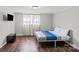 Bedroom with wood floors, a mounted TV, neutral paint, and a comfortable bed at 326 Whispering Pines Dr, Charlotte, NC 28217