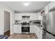 Well-equipped kitchen with white cabinets, granite countertops, and stainless steel appliances at 326 Whispering Pines Dr, Charlotte, NC 28217