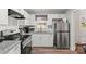 Modern kitchen with white cabinets, granite countertops, and stainless steel appliances at 326 Whispering Pines Dr, Charlotte, NC 28217