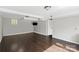 Living room featuring wood floors, neutral paint, trim work and a mounted TV to create a practical space at 326 Whispering Pines Dr, Charlotte, NC 28217