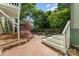 Private backyard featuring a brick patio, mature trees, and cozy outdoor seating area at 36 Yorktown Nw St, Concord, NC 28025