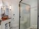 Stylish bathroom featuring patterned floors, vessel sink, and sleek glass shower at 36 Yorktown Nw St, Concord, NC 28025