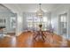 Bright dining room featuring hardwood floors, modern lighting, and clear acrylic chairs at 36 Yorktown Nw St, Concord, NC 28025