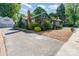 Charming bungalow-style home with brick chimney, well-manicured landscaping and a two-car garage at 36 Yorktown Nw St, Concord, NC 28025