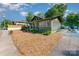 Stylish green bungalow-style home showcasing charming architectural details and a well-maintained yard at 36 Yorktown Nw St, Concord, NC 28025