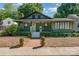 Charming green bungalow-style home featuring a cozy front porch and beautifully landscaped yard at 36 Yorktown Nw St, Concord, NC 28025