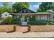 Charming green bungalow with a covered front porch, brick walkway, and lush landscaping at 36 Yorktown Nw St, Concord, NC 28025