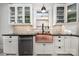 Stylish kitchen featuring white cabinets, black countertops, and a copper farmhouse sink under a window at 36 Yorktown Nw St, Concord, NC 28025