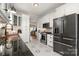Full view of the kitchen featuring black stainless appliances and white cabinetry at 36 Yorktown Nw St, Concord, NC 28025