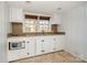 A cozy kitchenette featuring white cabinetry and a small window providing natural light at 36 Yorktown Nw St, Concord, NC 28025