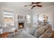 Cozy living room with fireplace, hardwood floors, large windows, and views into the dining room at 36 Yorktown Nw St, Concord, NC 28025