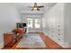 Home office with hardwood floors, built-in storage, large windows, and desk setup at 36 Yorktown Nw St, Concord, NC 28025