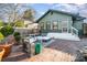 A brick patio with outdoor seating; view the home's exterior with classic details and a charming yard at 36 Yorktown Nw St, Concord, NC 28025
