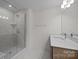 Modern bathroom featuring glass enclosed shower with tile surround and vanity with bright lighting at 4127 Walking Ridge Rd # 53, Charlotte, NC 28208