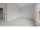 An empty bedroom with carpet, a single window and a door, offers a blank canvas for personal design and comfort at 4127 Walking Ridge Rd # 53, Charlotte, NC 28208