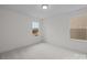 A light filled bedroom shows two windows and neutral carpet that creates a cozy atmosphere at 4127 Walking Ridge Rd # 53, Charlotte, NC 28208