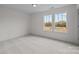 This bedroom has neutral carpet, and two windows that let in plenty of natural light, creating a peaceful atmosphere at 4127 Walking Ridge Rd # 53, Charlotte, NC 28208