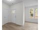 Bright entryway features wood-look flooring, white walls, and a front door with glass pane detailing at 4127 Walking Ridge Rd # 53, Charlotte, NC 28208