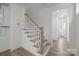 Elegant staircase featuring white risers, wood treads, and a matching wood handrail for a classic design at 4127 Walking Ridge Rd # 53, Charlotte, NC 28208