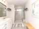 Bright bathroom with single vanity, a framed mirror, and a glass enclosed shower at 426 Kenwood Vw, Indian Trail, NC 28079