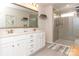 Bright bathroom featuring double vanity, framed mirror, and glass enclosed shower with neutral tiling at 426 Kenwood Vw, Indian Trail, NC 28079