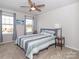 Bedroom with ceiling fan and natural light featuring carpeted floors and neutral walls at 426 Kenwood Vw, Indian Trail, NC 28079