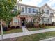 Charming townhome featuring a stone facade, black front door, and landscaped front yard at 426 Kenwood Vw, Indian Trail, NC 28079