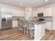 Well-lit kitchen featuring a central island with seating, stainless steel appliances, and subway tile at 426 Kenwood Vw, Indian Trail, NC 28079