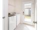 Bright laundry room featuring a white washer and dryer, as well as a doorway to the backyard at 426 Kenwood Vw, Indian Trail, NC 28079