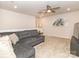 Cozy living room featuring plush seating, a ceiling fan, and neutral carpeting at 426 Kenwood Vw, Indian Trail, NC 28079
