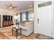 Bright living room with large sectional couch, modern lighting, and front door at 426 Kenwood Vw, Indian Trail, NC 28079