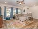 Bright living room showcasing a stylish sectional, modern fan, and expansive windows at 426 Kenwood Vw, Indian Trail, NC 28079