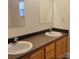 Bathroom featuring double sinks, ample counter space, and well-lit mirrors at 4612 Waterbell Ln, Waxhaw, NC 28173